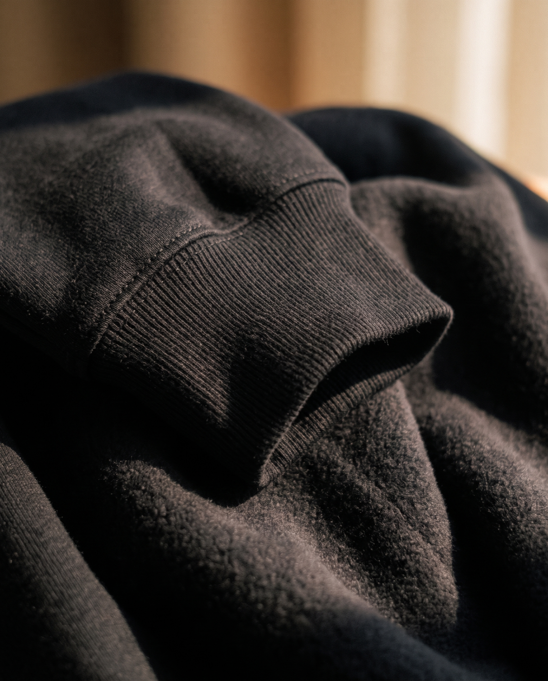 Close-up of the ribbed cuff and brushed fleece of an EHA & CO. crewneck